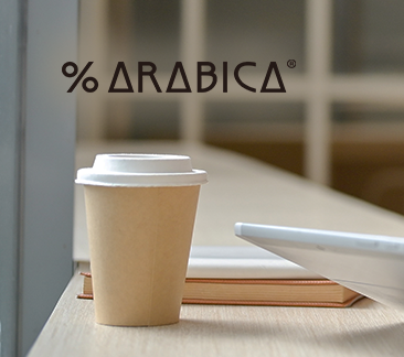 Person working on tablet with coffee